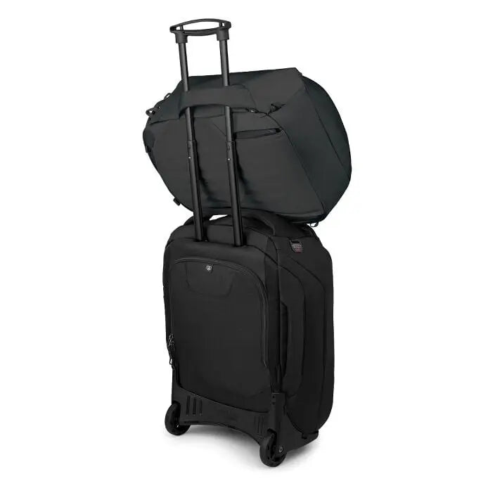 Osprey Sojourn Porter 30L (2026) - travel pack resting on wheeled luggage; luggage is not included, shown in Black