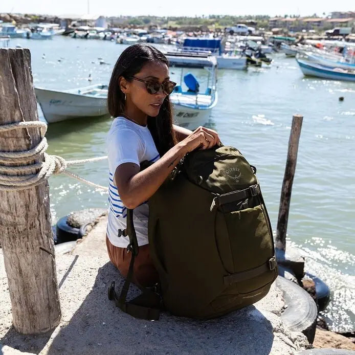 Osprey Sojourn Porter 46L (2026) - waterside travel lifestyle, shown in Moss Green