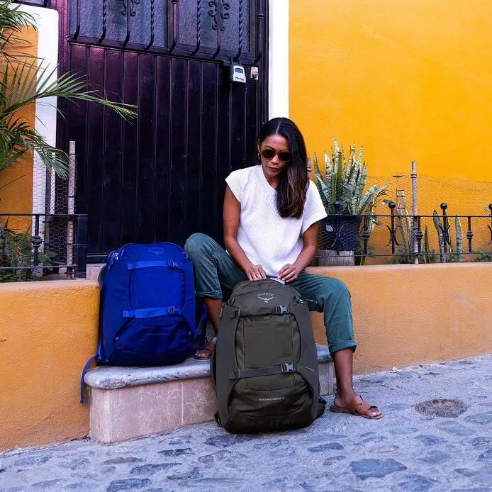 Osprey Sojourn Porter 46L (2026) - 46L travel pack beside a Deep Fig 30L pack; second pack is not included, shown in Moss Green