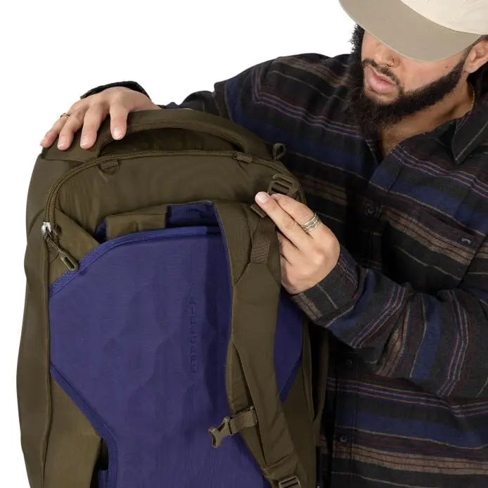 Osprey Sojourn Porter 46L (2026) - zipping the stowaway harness cover, shown in Moss Green