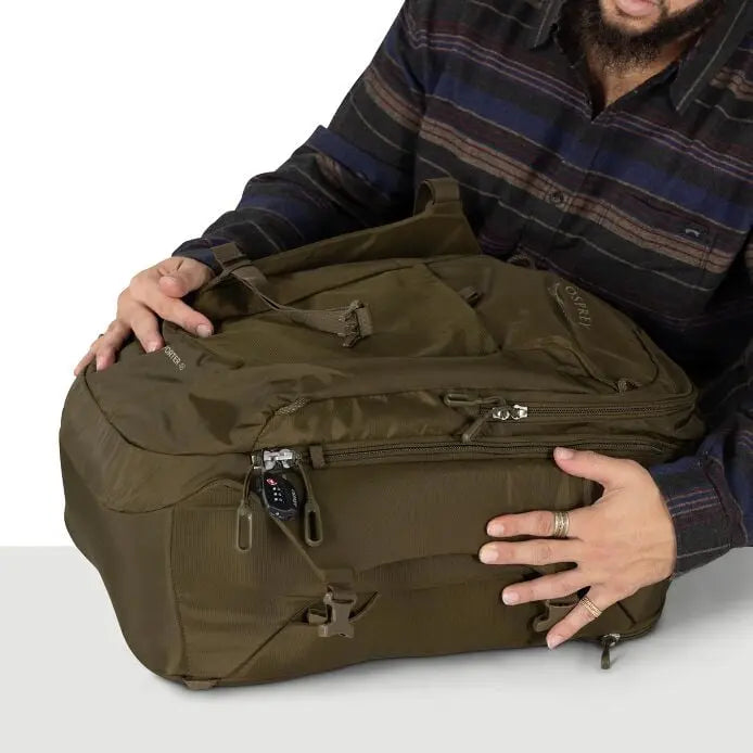 Osprey Sojourn Porter 46L (2026) - compression with the pack laid flat, shown in Moss Green