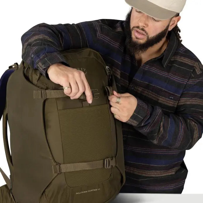 Osprey Sojourn Porter 46L (2026) - quick-access zip pocket demonstration, shown in Moss Green