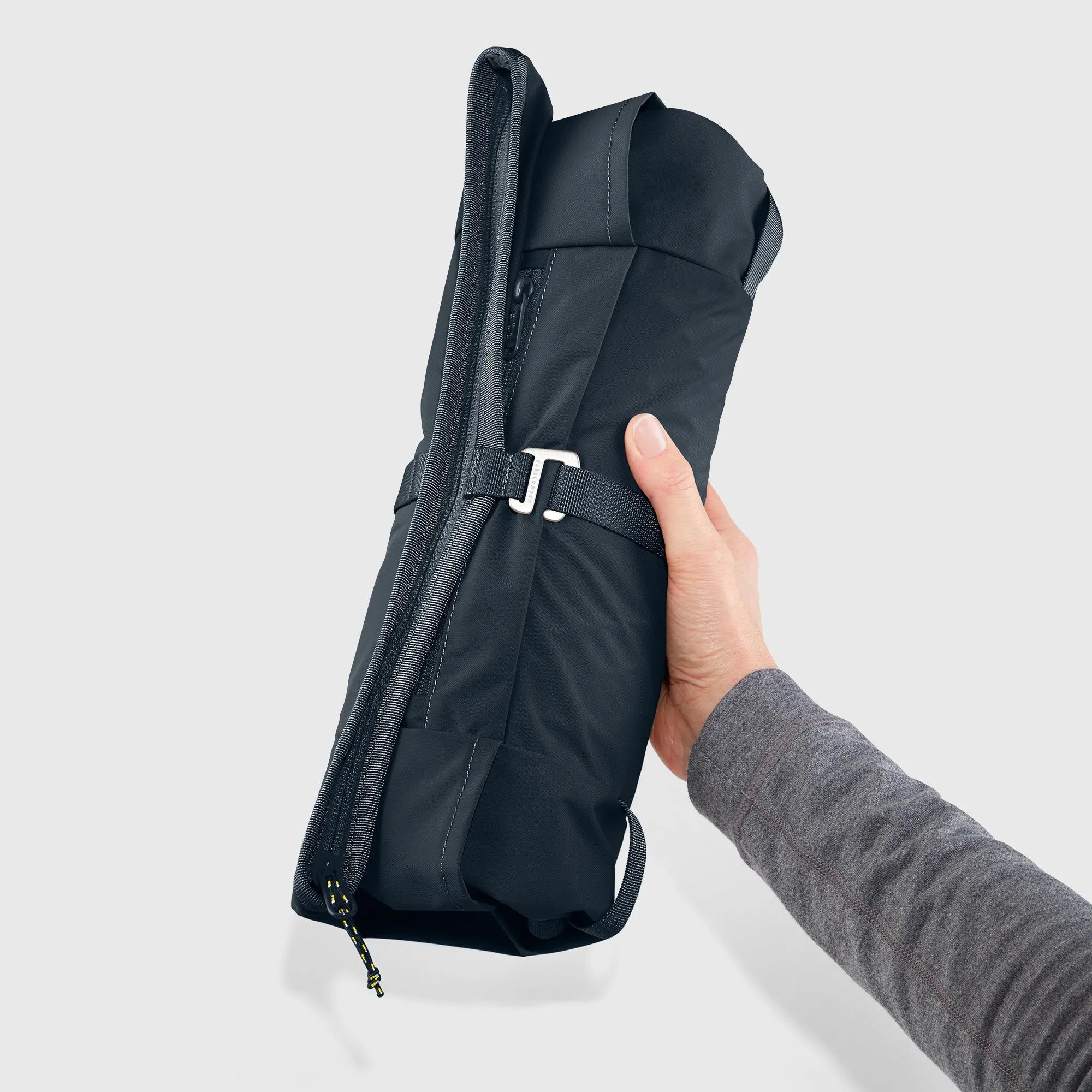 Fjallraven High Coast Foldsack 24, rolled pack held in one hand, shown in Navy; shared feature image
