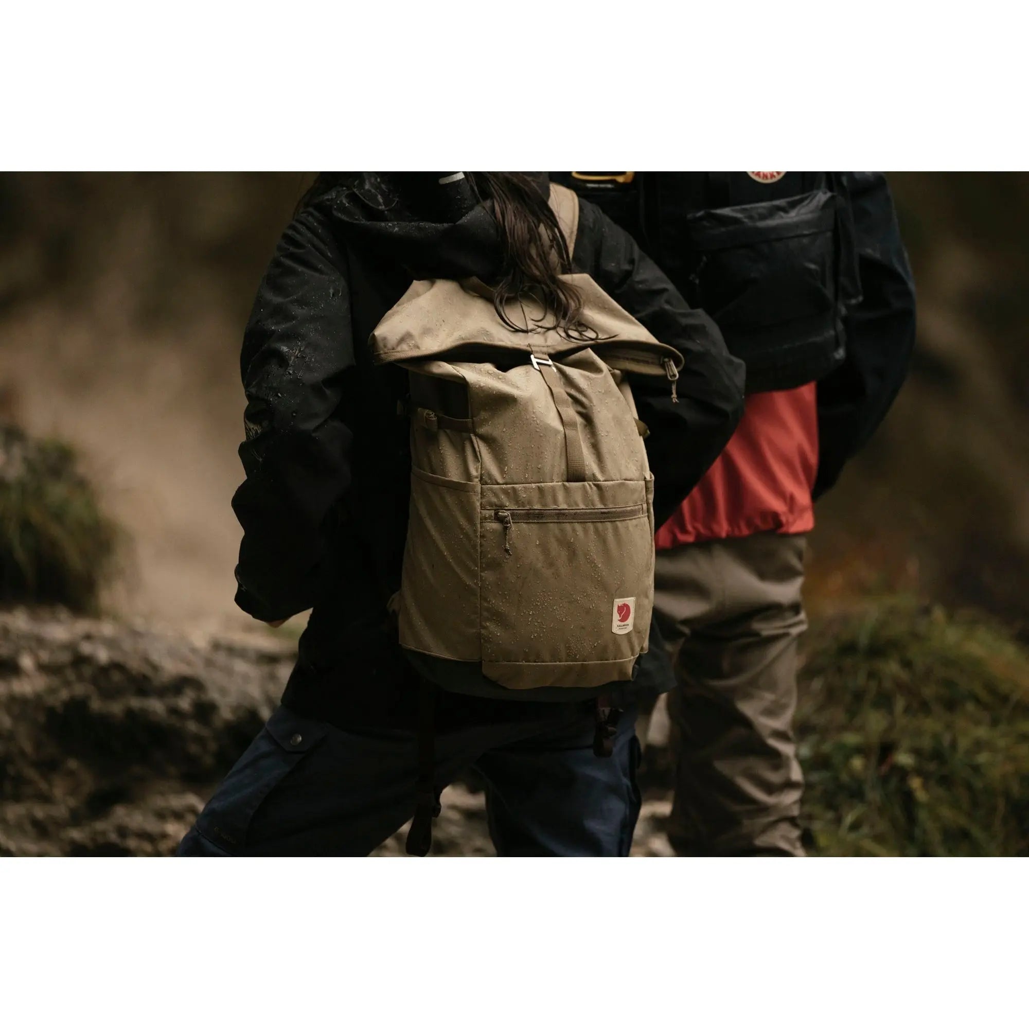 Fjallraven High Coast Foldsack 24, worn outdoors on a trail, shown in olive green; shared feature image