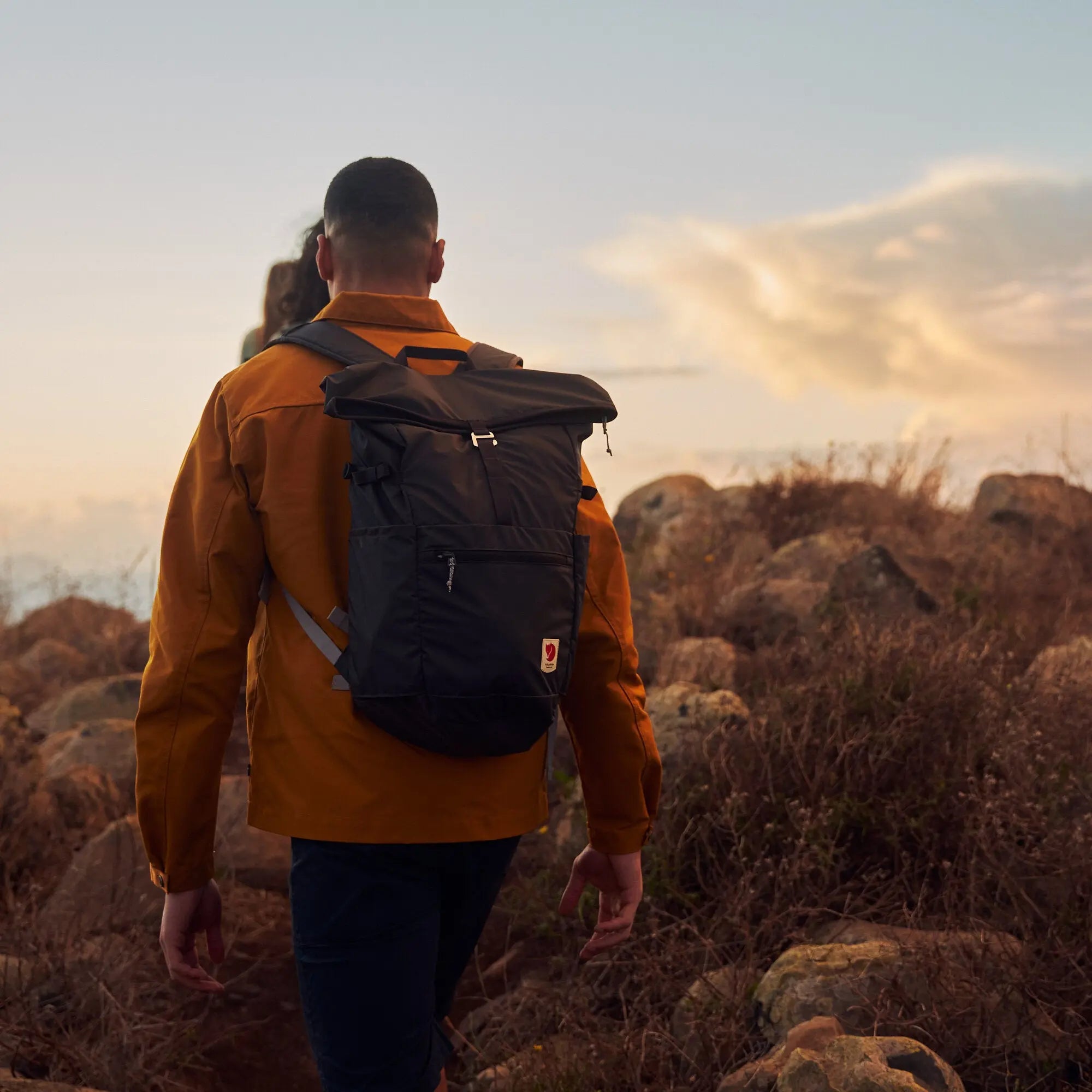 Fjallraven High Coast Foldsack 24, worn outdoors at sunset, shown in navy; shared feature image
