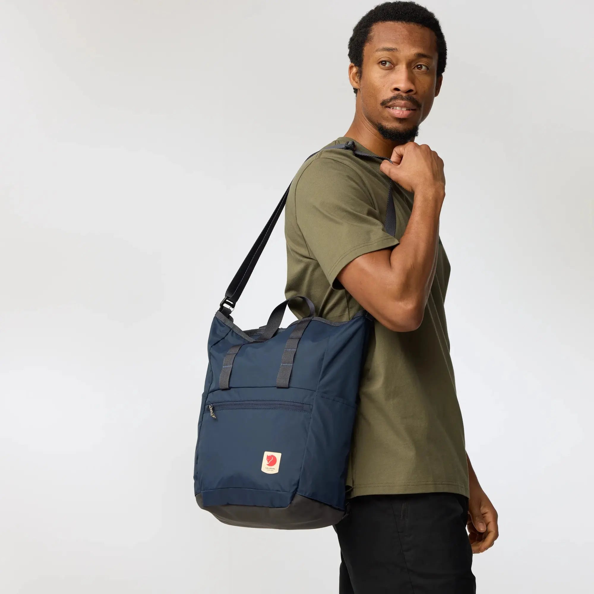 Fjallraven High Coast Totepack, shoulder carry on a model, shown in Navy; shared feature image