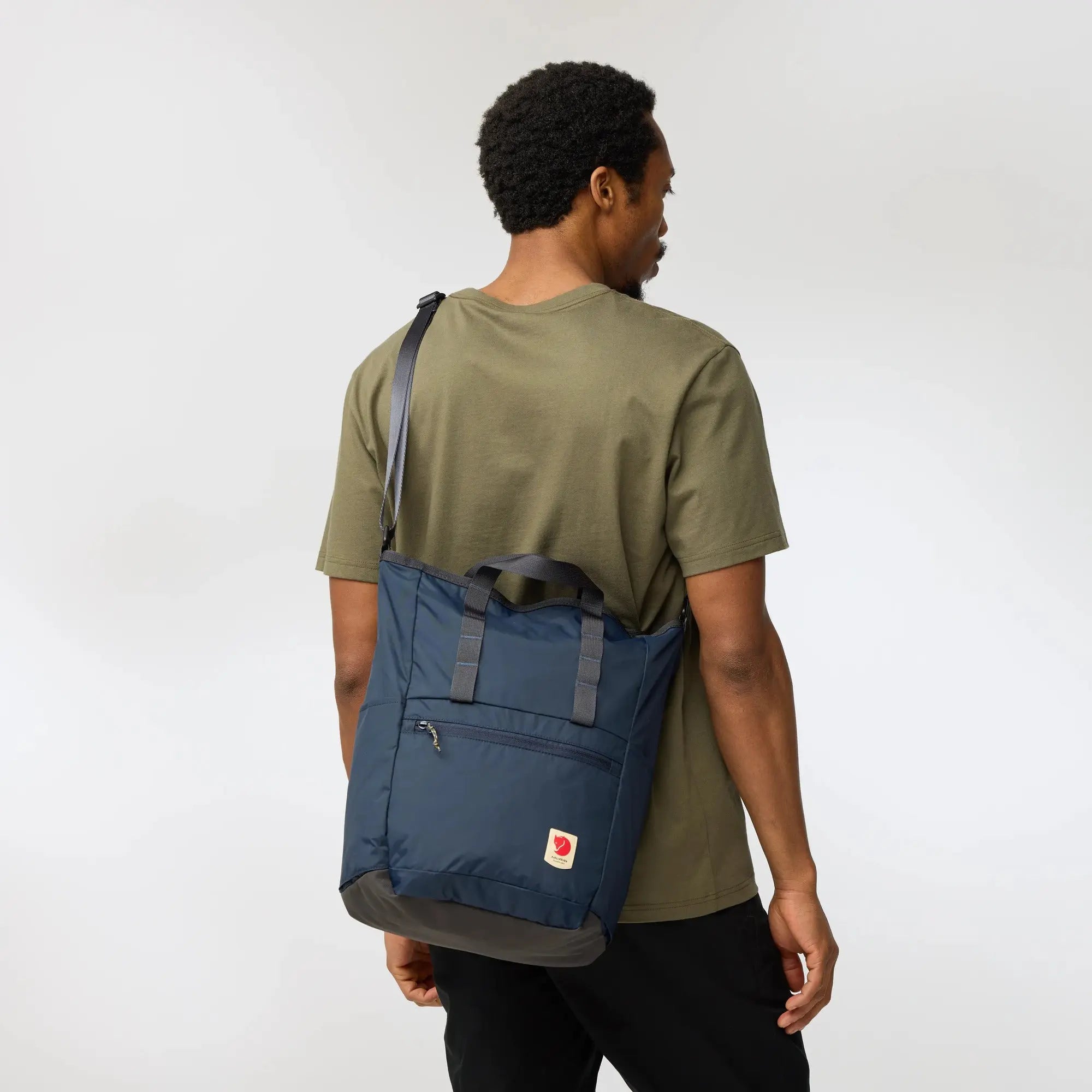 Fjallraven High Coast Totepack, crossbody carry viewed from behind, shown in Navy; shared feature image