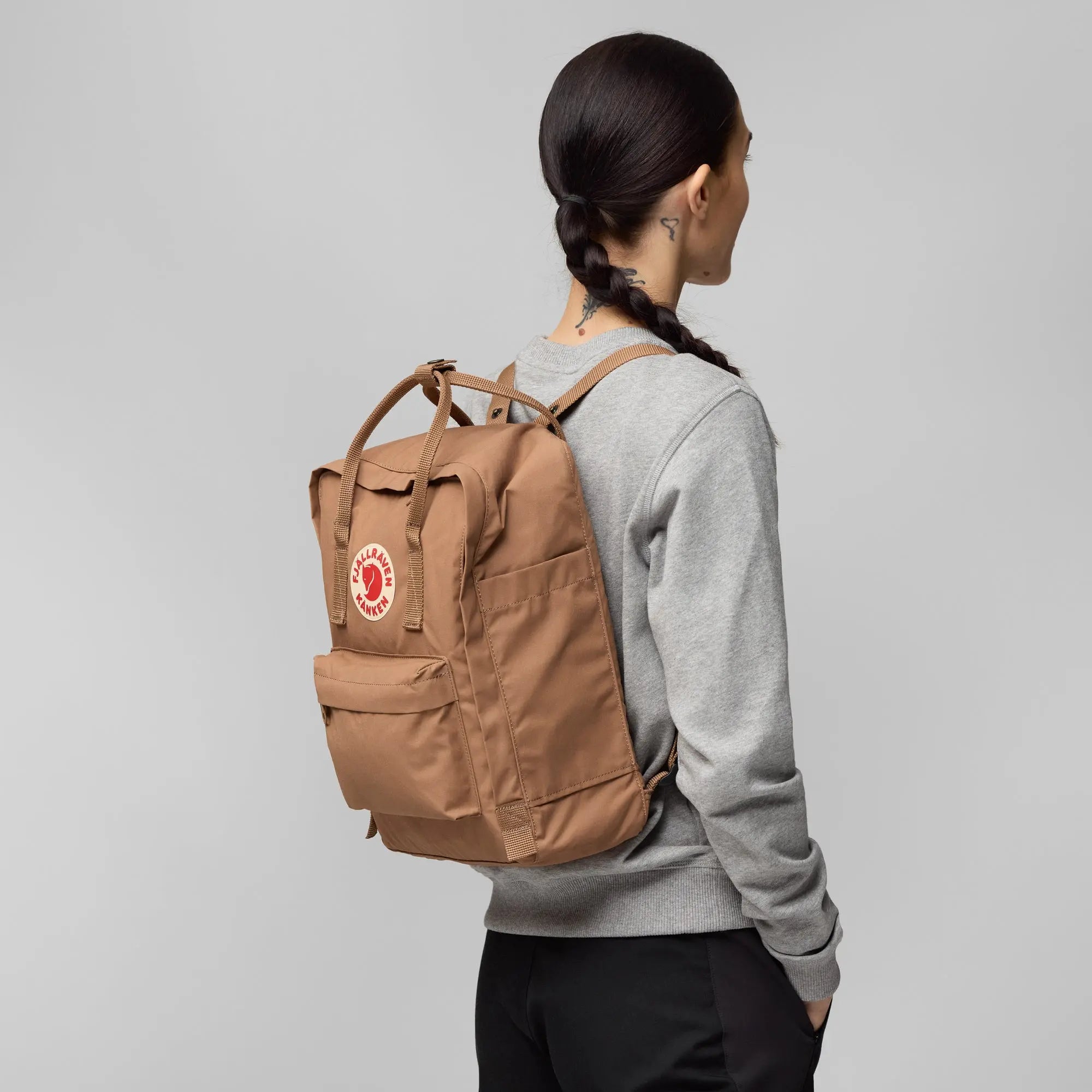 Fjallraven Kanken Backpack, side backpack fit on a model, shown in Khaki Dust; shared feature image
