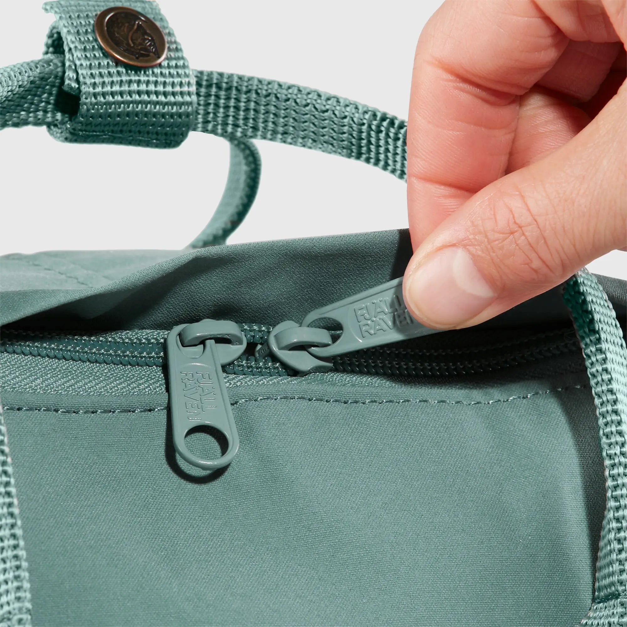 Fjallraven Kanken Backpack, zipper opening detail, shown in Frost Green; shared feature image