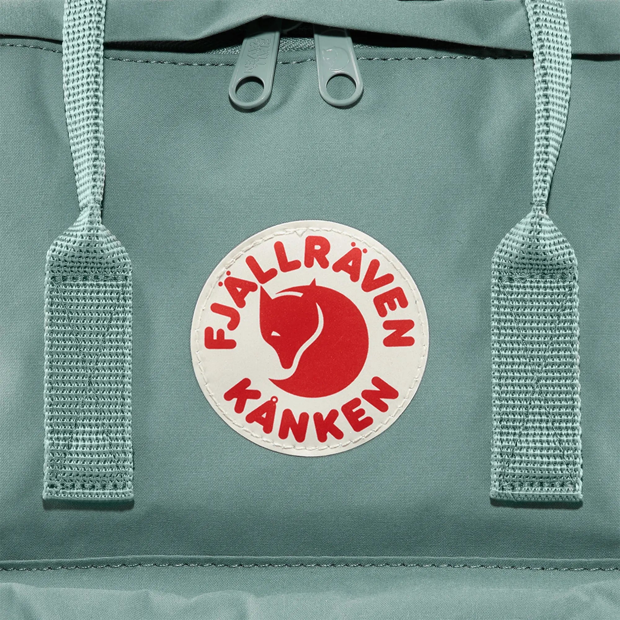 Fjallraven Kanken Backpack, round logo and top handles, shown in Frost Green; shared feature image