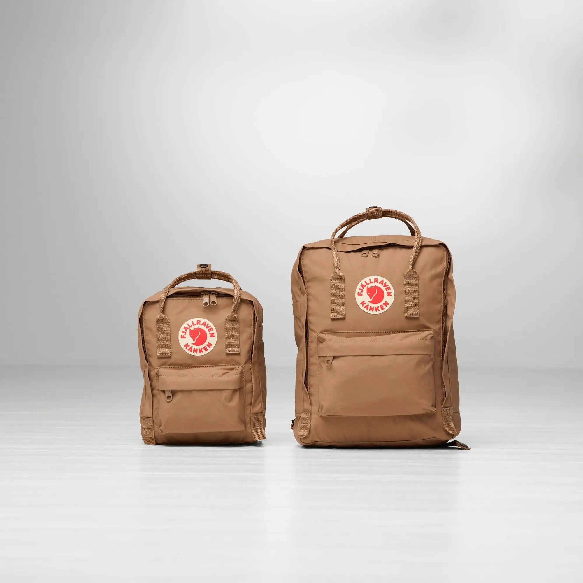 Fjallraven Kanken Mini Backpack, Kanken Mini and full-size Kanken side by side, shown in Khaki Dust; bags sold separately; shared feature image