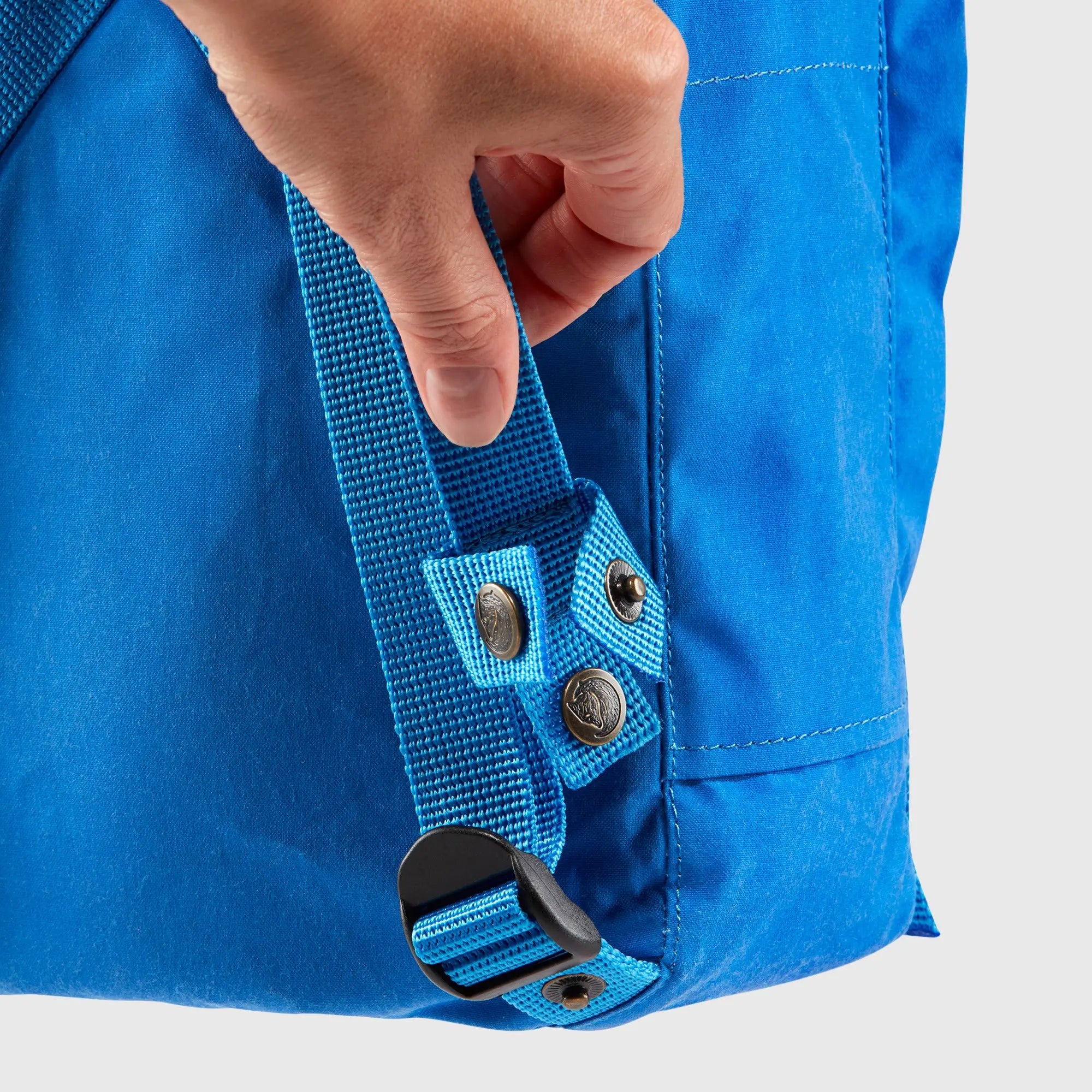 Fjallraven Kanken Mini Backpack, shoulder-strap snap detail, shown in blue; shared feature image