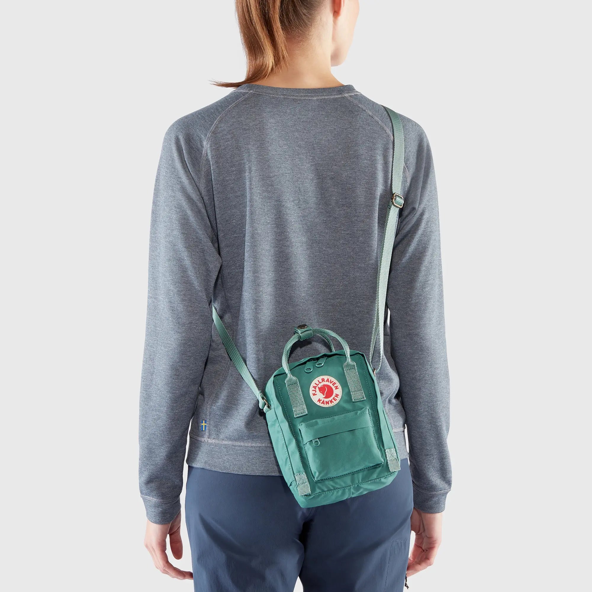Fjallraven Kanken Sling, rear crossbody fit on a model, shown in Frost Green; shared feature image
