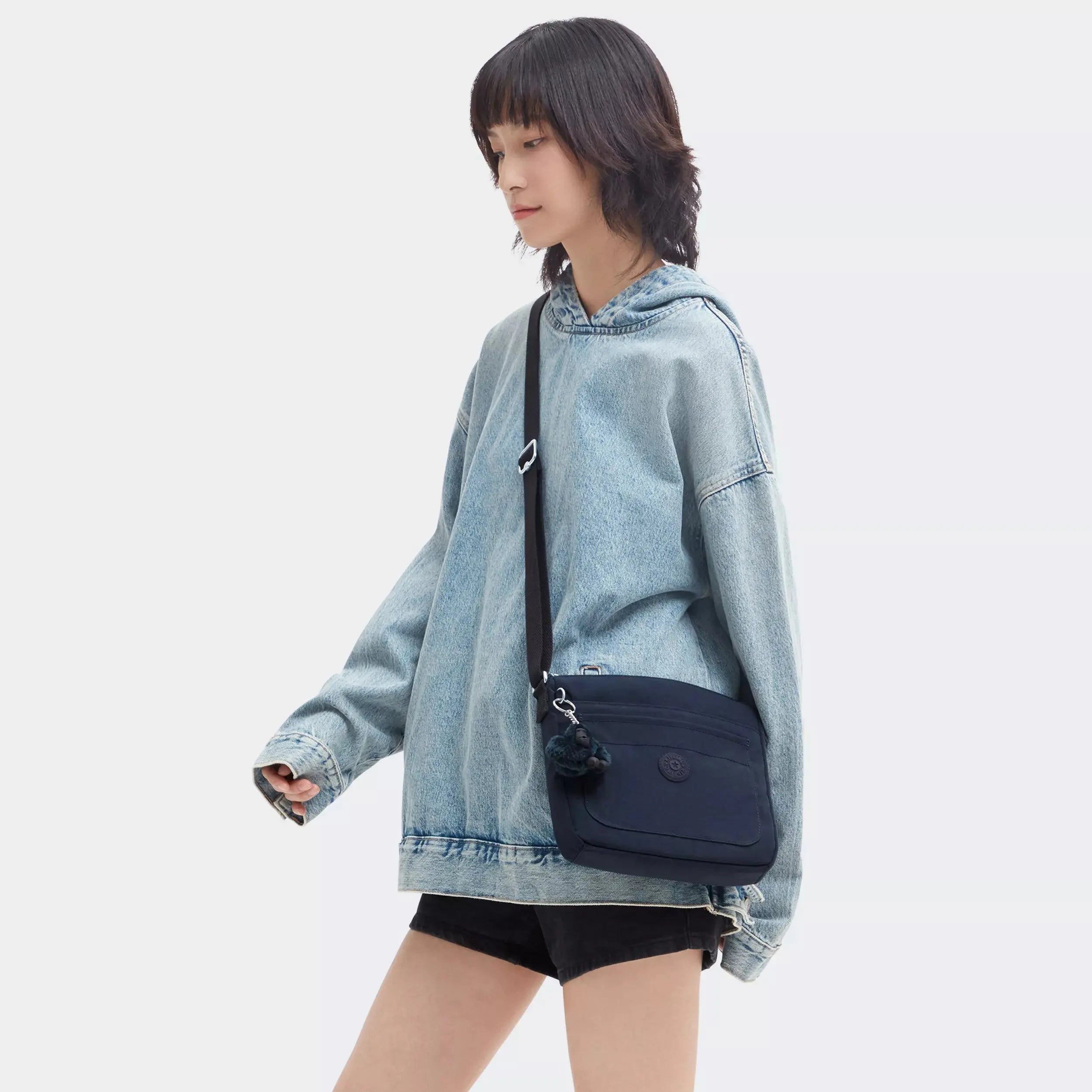 Kipling Sebastian Crossbody Bag in Blue Bleu 2, worn by a model