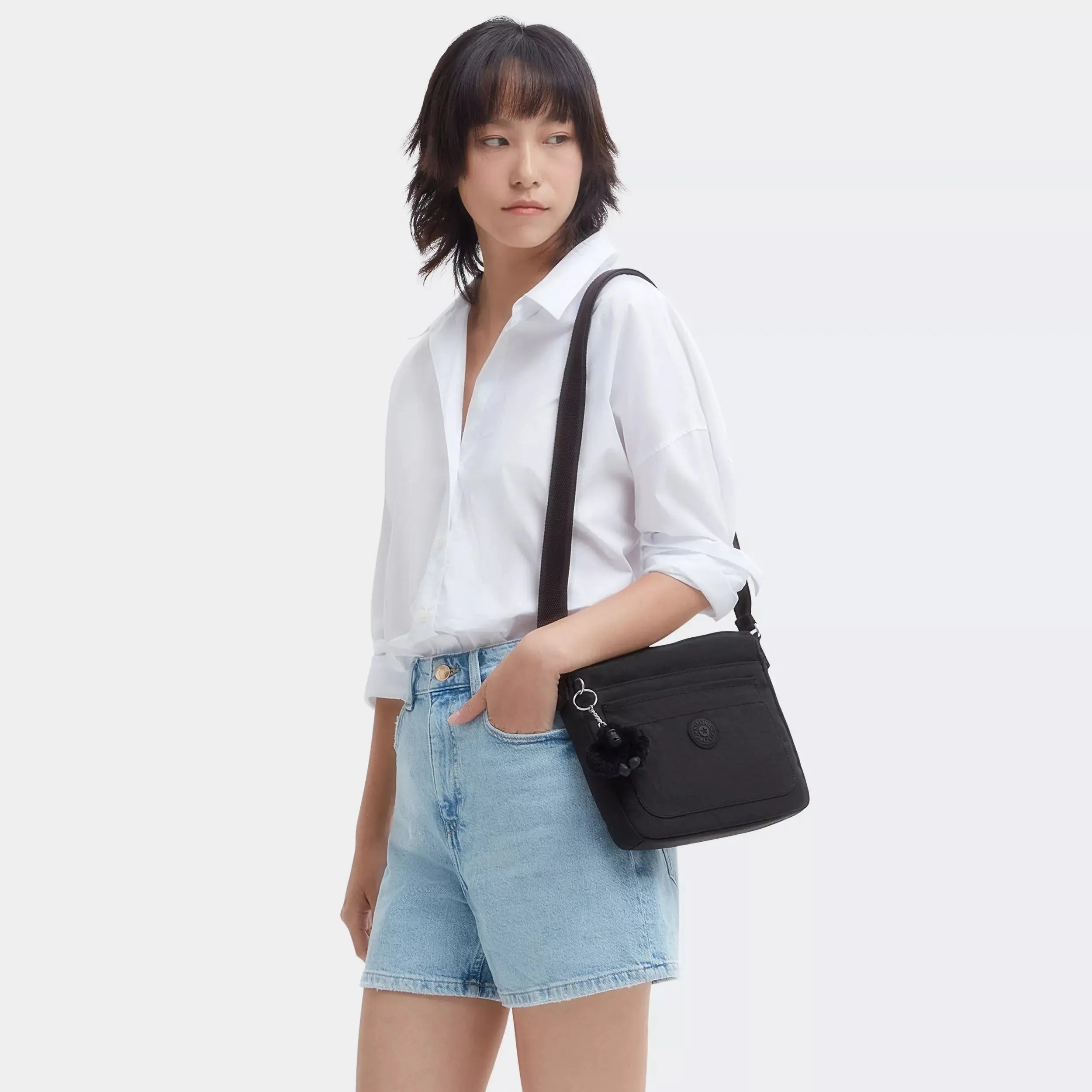 Kipling Sebastian Crossbody Bag in Black Noir, worn by a model