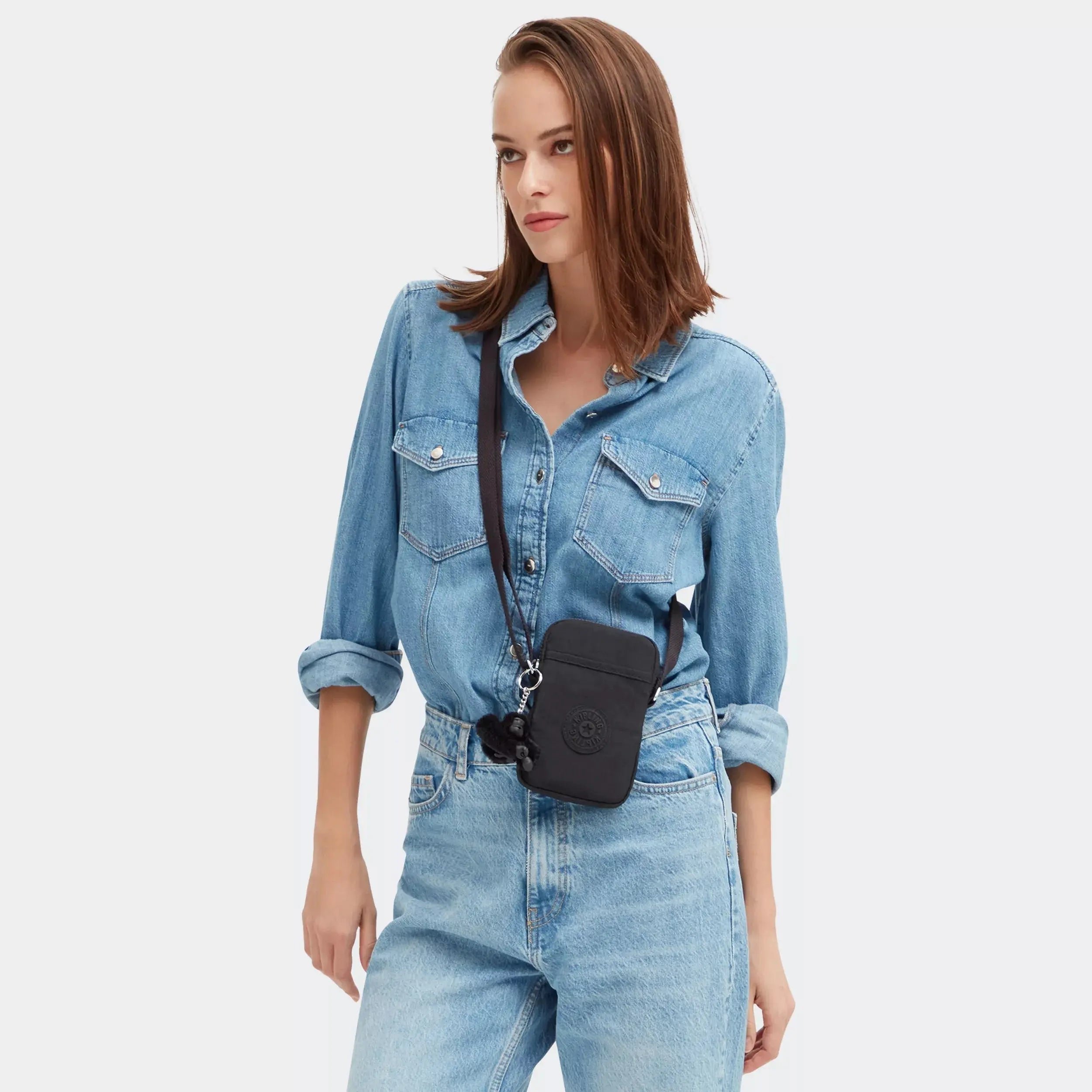 Kipling Tally Crossbody Phone Bag in Black Noir, worn by a model