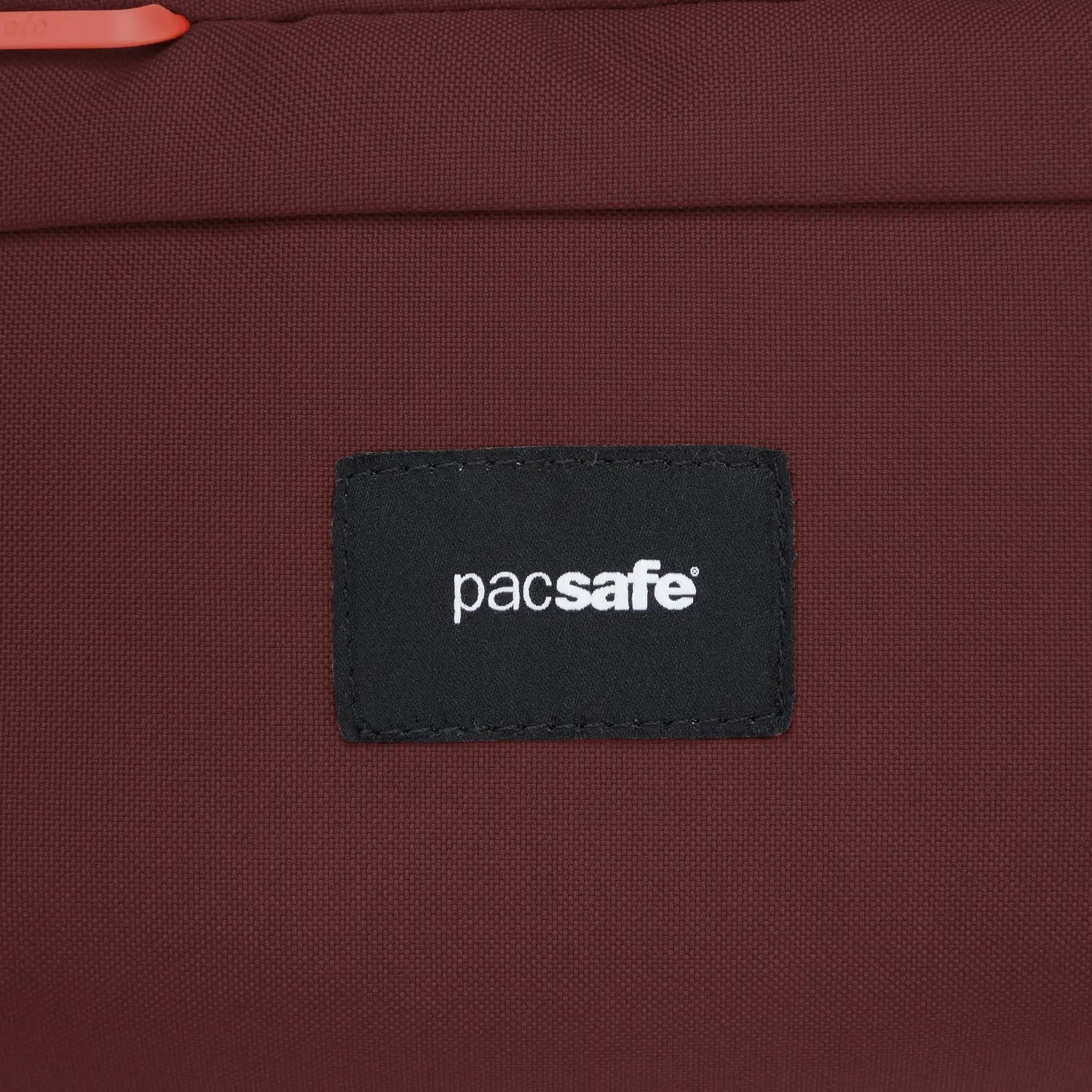 Pacsafe GO Sling Pack, Garnet Red — brand patch detail