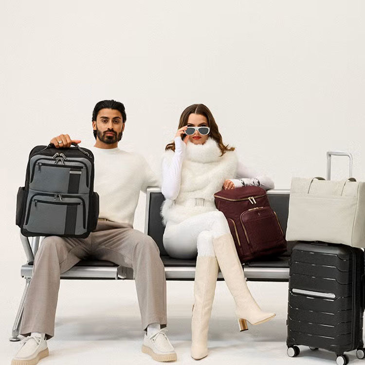 man and woman sitting with luggage