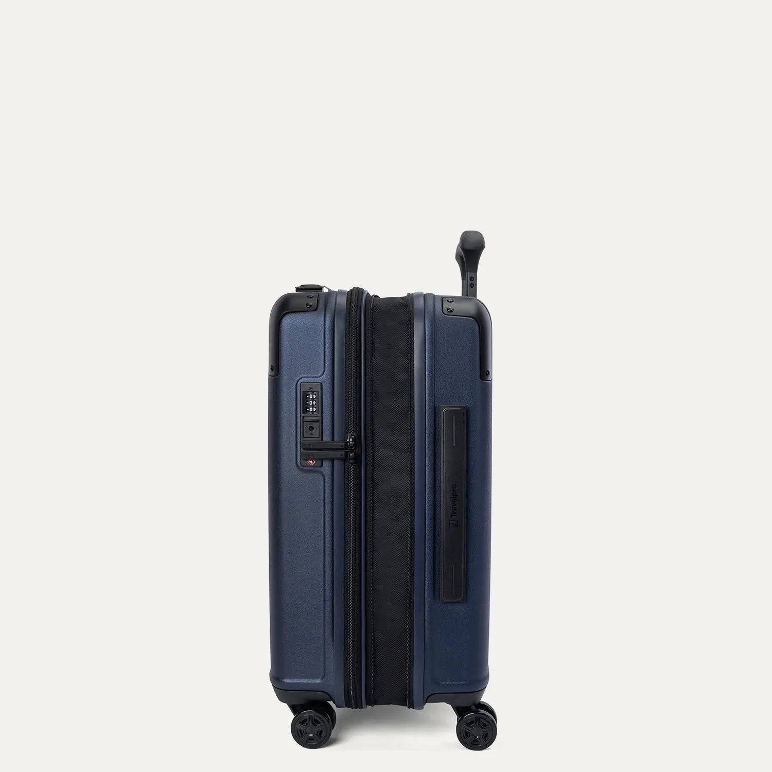 side profile view of the travelpro platinum elite compact carry-on hardside spinner in aviator navy, featuring the zippered 2-inch expansion gusset for additional packing capacity and the integrated tsa lock.