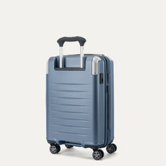 Rear angled view of the Travelpro Platinum Elite Compact Carry-On Hardside Spinner in Dark Sky Blue, showing the durable polycarbonate shell, the PowerScope Lite telescoping handle, and the dual spinner wheels.