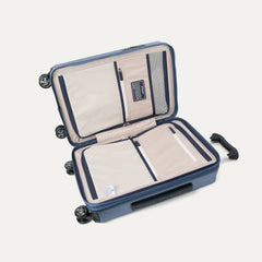 interior packing view of the travelpro platinum elite compact carry-on hardside spinner in dark sky blue, featuring dual zippered divider panels and ecofab™ lining made from 100% recycled plastic bottles.