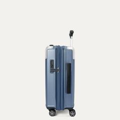 side profile view of the travelpro platinum elite compact carry-on hardside spinner in dark sky blue, showcasing the slim design, integrated tsa lock, and the 2-inch expansion gusset.