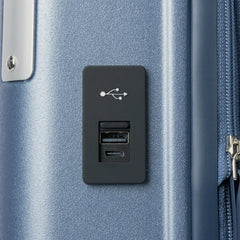 macro detail view of the external usb-a and usb-c charging ports on the travelpro platinum elite compact carry-on hardside spinner in dark sky blue, highlighting the integrated power connectivity.