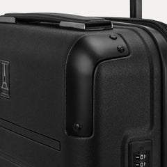Close-up detail of the Travelpro Platinum Elite Compact Carry-On Hardside Spinner in Shadow Black, highlighting the polished aluminum corner armor and the integrated TSA-approved combination lock.