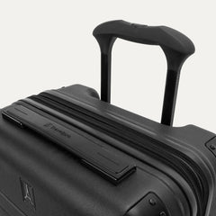 Close-up detail of the Travelpro Platinum Elite Compact Carry-On Hardside Spinner in Shadow Black, showing the low-profile top carry handle with the Travelpro logo and the sturdy PowerScope Lite telescoping handle.