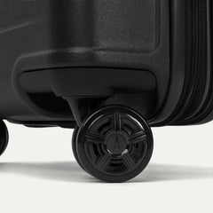 Close-up of the high-performance spinner wheels on the Travelpro Platinum Elite Compact Carry-On Hardside Spinner in Shadow Black, featuring self-aligning MagnaTrac® technology for effortless 360-degree mobility.