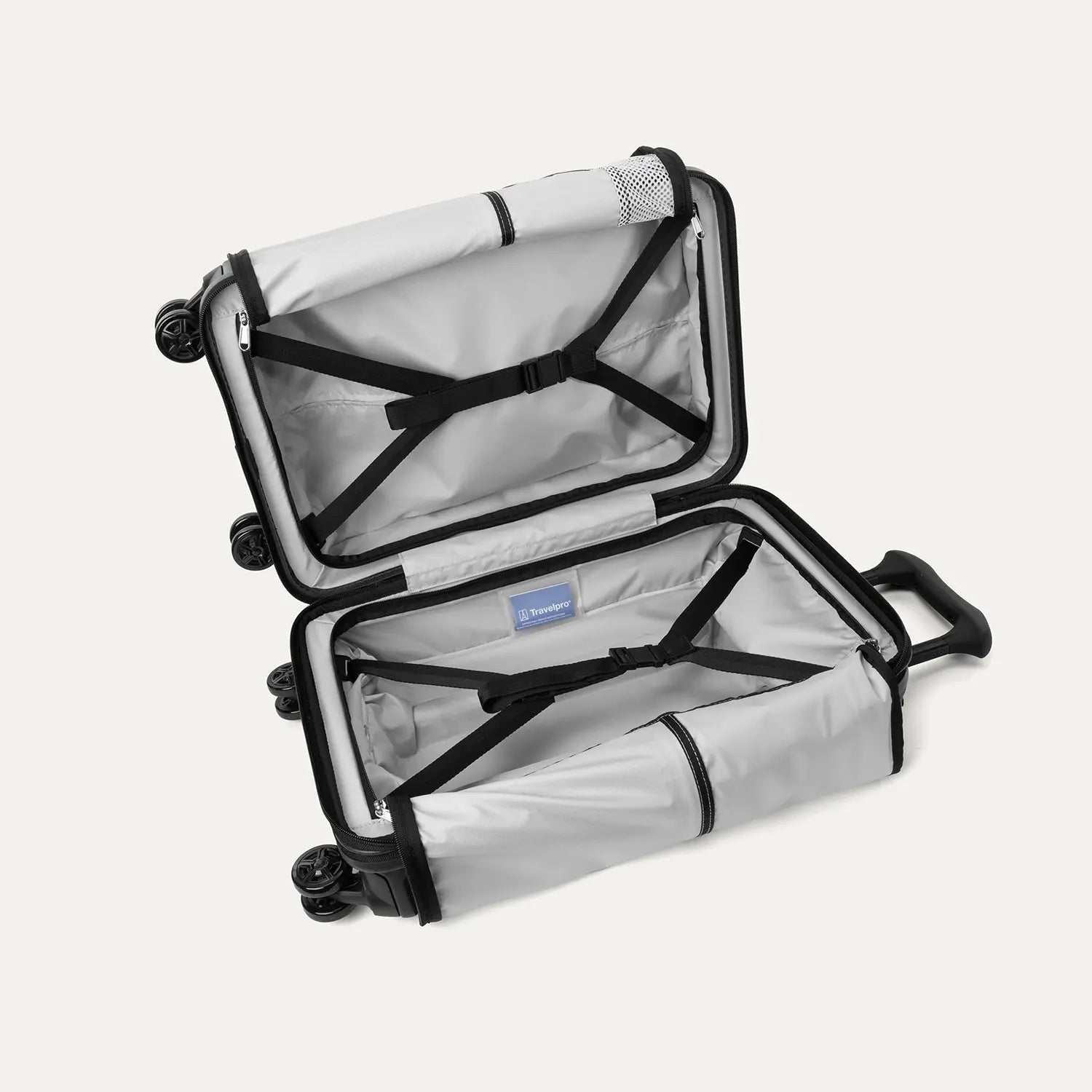 Interior packing view of the Travelpro Platinum Elite Compact Carry-On Hardside Spinner in Aviator Navy, showing the organized compartment with adjustable hold-down straps and the signature ECOFAB™ lining.