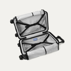 Interior packing view of the Travelpro Platinum Elite Compact Carry-On Hardside Spinner in Aviator Navy, showing the organized compartment with adjustable hold-down straps and the signature ECOFAB™ lining.