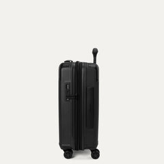Side profile view of the Travelpro Platinum Elite Compact Carry-On Hardside Spinner in Aviator Navy, showcasing the slim design, integrated TSA lock, and the 2-inch expansion gusset.