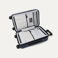 interior packing view of the open travelpro platinum elite compact carry-on hardside spinner in aviator navy, featuring dual zippered divider panels and ecofab™ lining made from 100% recycled plastic bottles.