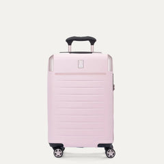 Front view of the light pink Travelpro Platinum Elite Next Gen Powder Pink Suitcase, showing the hardshell spinner with an extended black ProGrip telescoping handle, top carry handle, metallic corner guards, and multi-directional spinner wheels against a clean off-white background.