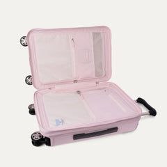 Open interior view of the light pink Travelpro Platinum Elite Next Gen Powder Pink Suitcase, showing the main packing compartment with zippered dividers, mesh pockets, and multi-directional spinner wheels against a clean off-white background.