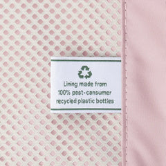 Close-up detail of the ECOFAB lining inside the Travelpro Platinum Elite Next Gen Powder Pink Suitcase, featuring a white fabric label that reads "Lining made from 100% post-consumer recycled plastic bottles" with a green recycling symbol against the pink mesh interior.