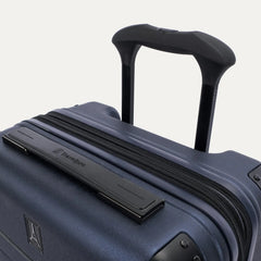 close-up detail of the travelpro platinum elite compact carry-on hardside spinner in aviator navy, showing the low-profile top carry handle with the travelpro logo and the sturdy powerscope lite telescoping handle.