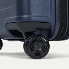 Close-up of the high-performance spinner wheels on the Travelpro Platinum Elite Carry-On Hardside Spinner in Aviator Navy, featuring self-aligning MagnaTrac® technology for effortless 360-degree mobility.