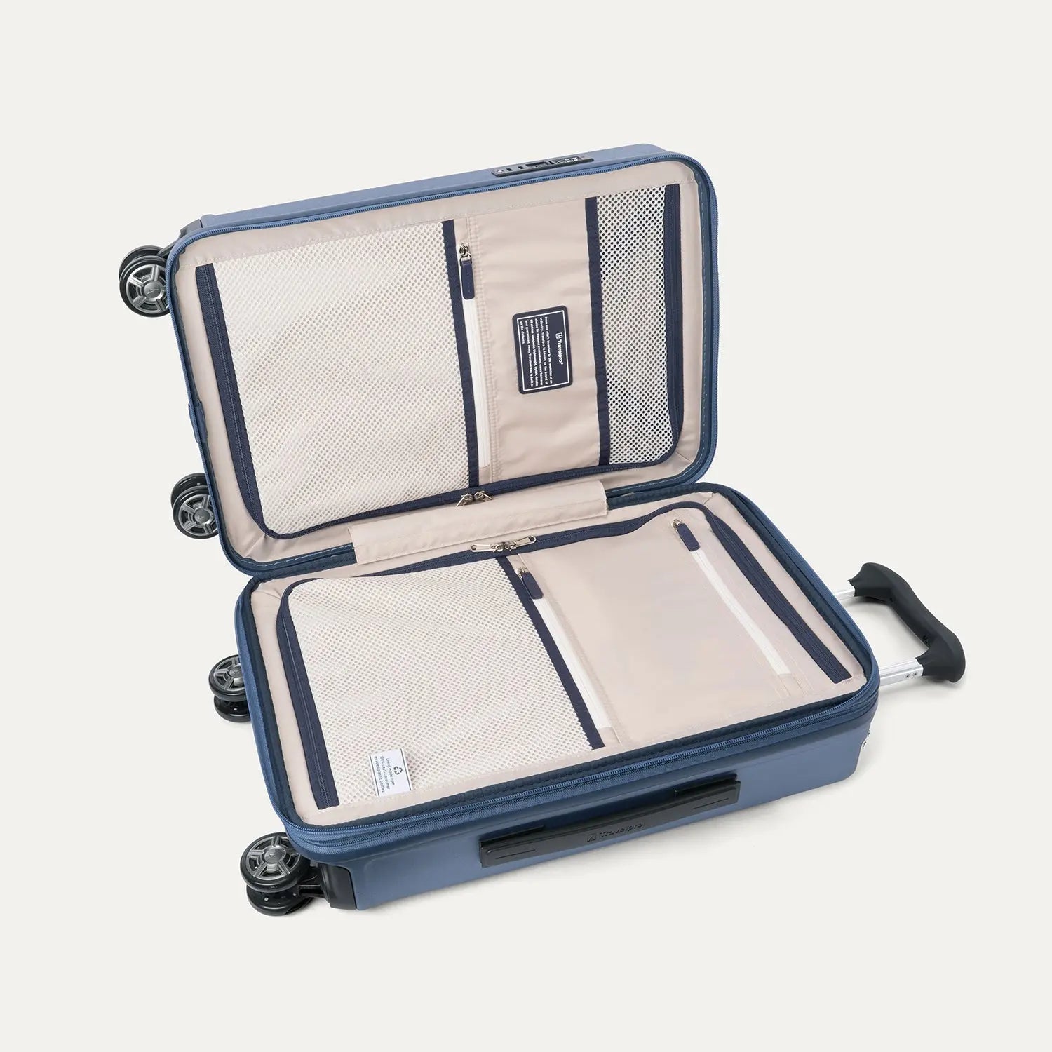 Interior packing view of the Travelpro Platinum Elite Carry-On Hardside Spinner in Dark Sky Blue, featuring dual zippered divider panels and the ECOFAB™ lining made from 100% recycled plastic bottles.