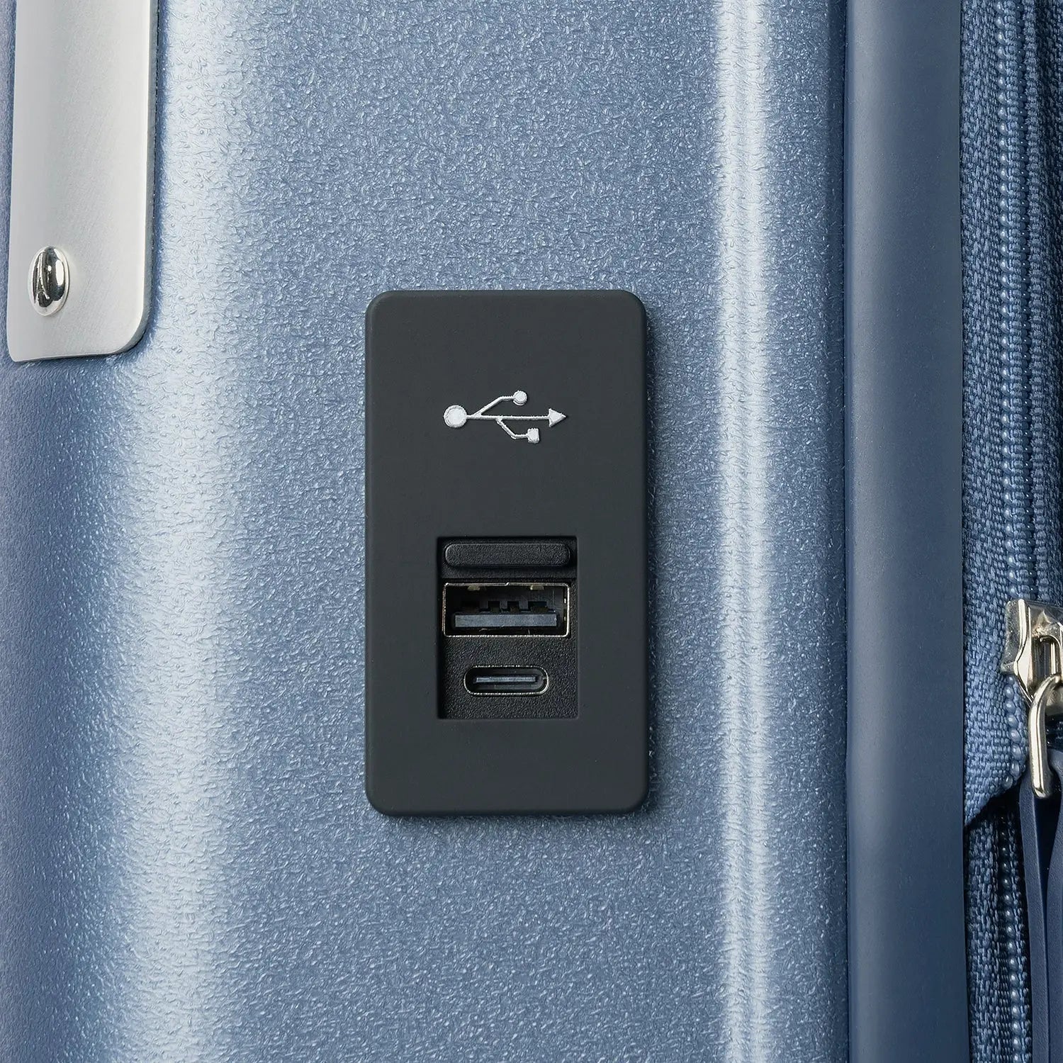 Macro detail view of the external USB-A and USB-C charging ports on the Travelpro Platinum Elite Carry-On Hardside Spinner in Dark Sky Blue, highlighting the integrated power connectivity for mobile devices.