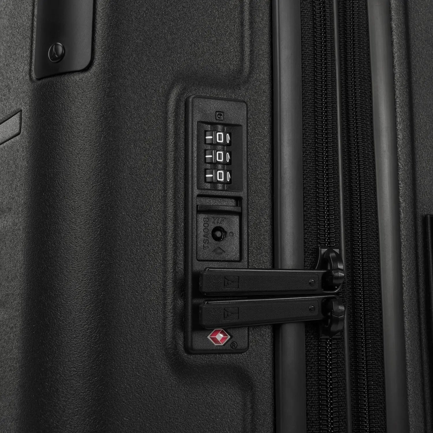 Close-up detail of the Travelpro Platinum Elite Carry-On Hardside Spinner in Jet Black, showing the integrated TSA-approved combination lock and secure zipper pulls on the durable polycarbonate shell.