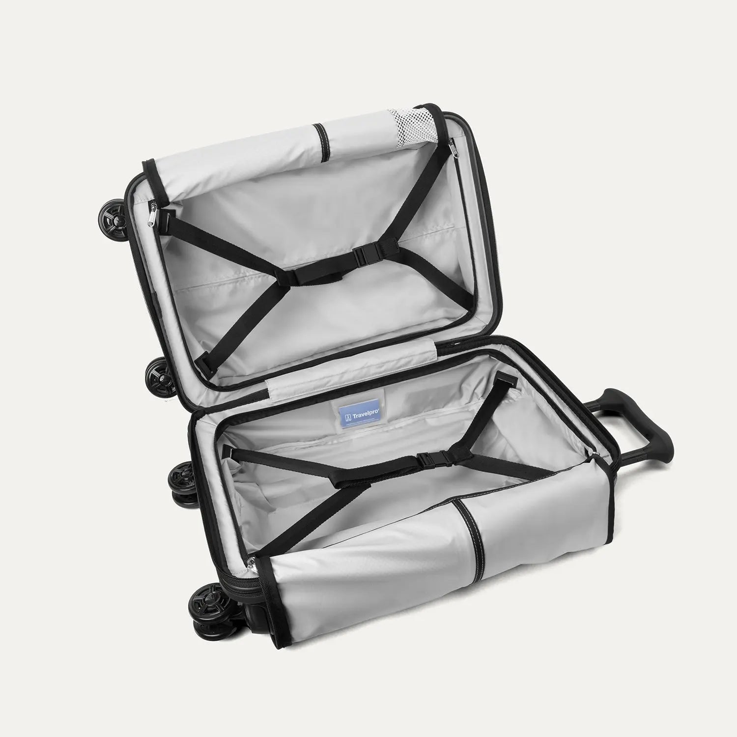 Fully open interior packing view of the Travelpro Platinum Elite Carry-On Hardside Spinner in Jet Black, showing the main compartment with adjustable hold-down straps and the ECOFAB™ lining made from recycled plastic bottles.