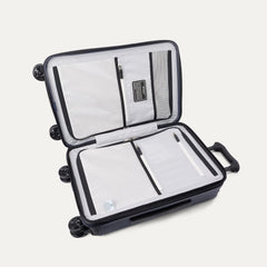 Interior packing view of the Travelpro Platinum Elite Carry-On Hardside Spinner in Aviator Navy, featuring dual zippered divider panels and the ECOFAB™ lining made from 100% recycled plastic bottles.