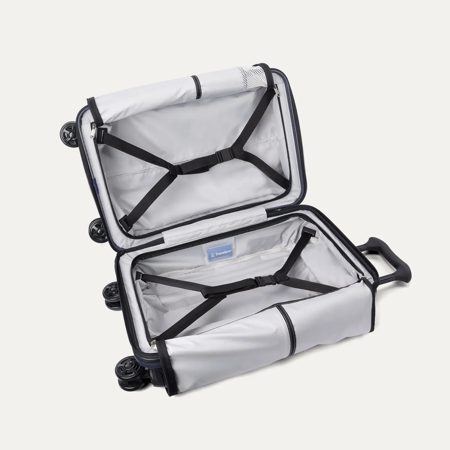 Fully open interior packing view of the Travelpro Platinum Elite Carry-On Hardside Spinner in Aviator Navy, showing the main compartment with adjustable hold-down straps and the sustainable ECOFAB™ lining.