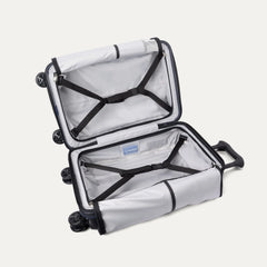 Fully open interior packing view of the Travelpro Platinum Elite Carry-On Hardside Spinner in Aviator Navy, showing the main compartment with adjustable hold-down straps and the sustainable ECOFAB™ lining.