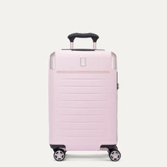 Front view of the light pink Travelpro Platinum Elite Next Gen Powder Pink Suitcase, showing the hardshell spinner with an extended black ProGrip telescoping handle, top carry handle, metallic corner guards, and multi-directional spinner wheels against a clean off-white background.