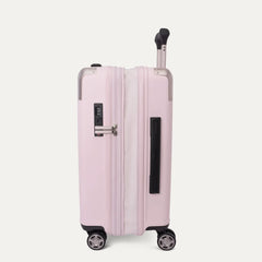Side-three-quarters view of the light pink Travelpro Platinum Elite Next Gen Powder Pink Suitcase, showing the hardshell spinner with an extended telescoping handle, vertical side handle, TSA combination lock, and multi-directional spinner wheels against a clean off-white background.