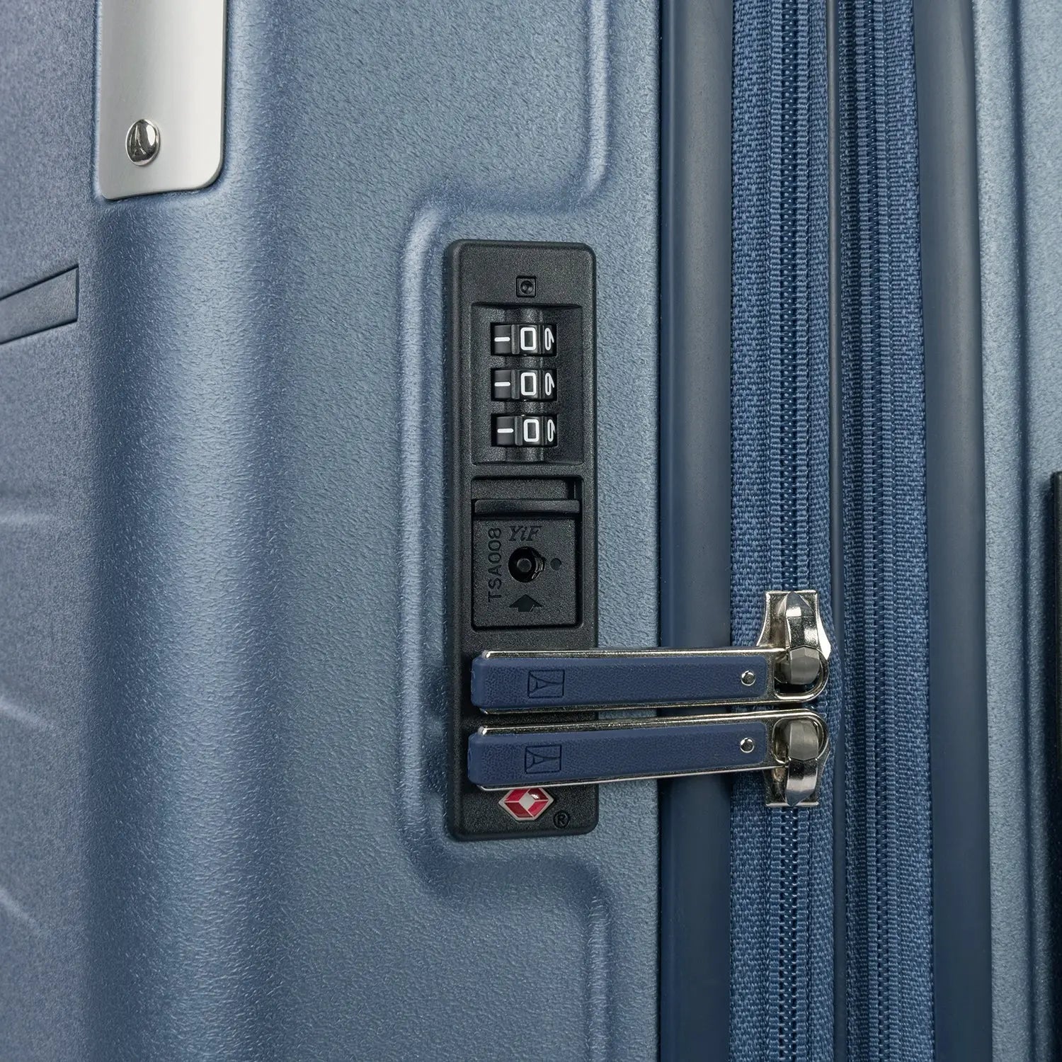 Close-up detail of the Travelpro Platinum Elite Medium Check-In Hardside Spinner in Dark Sky Blue, showing the integrated TSA-approved combination lock and secure zipper pulls on the polycarbonate shell.