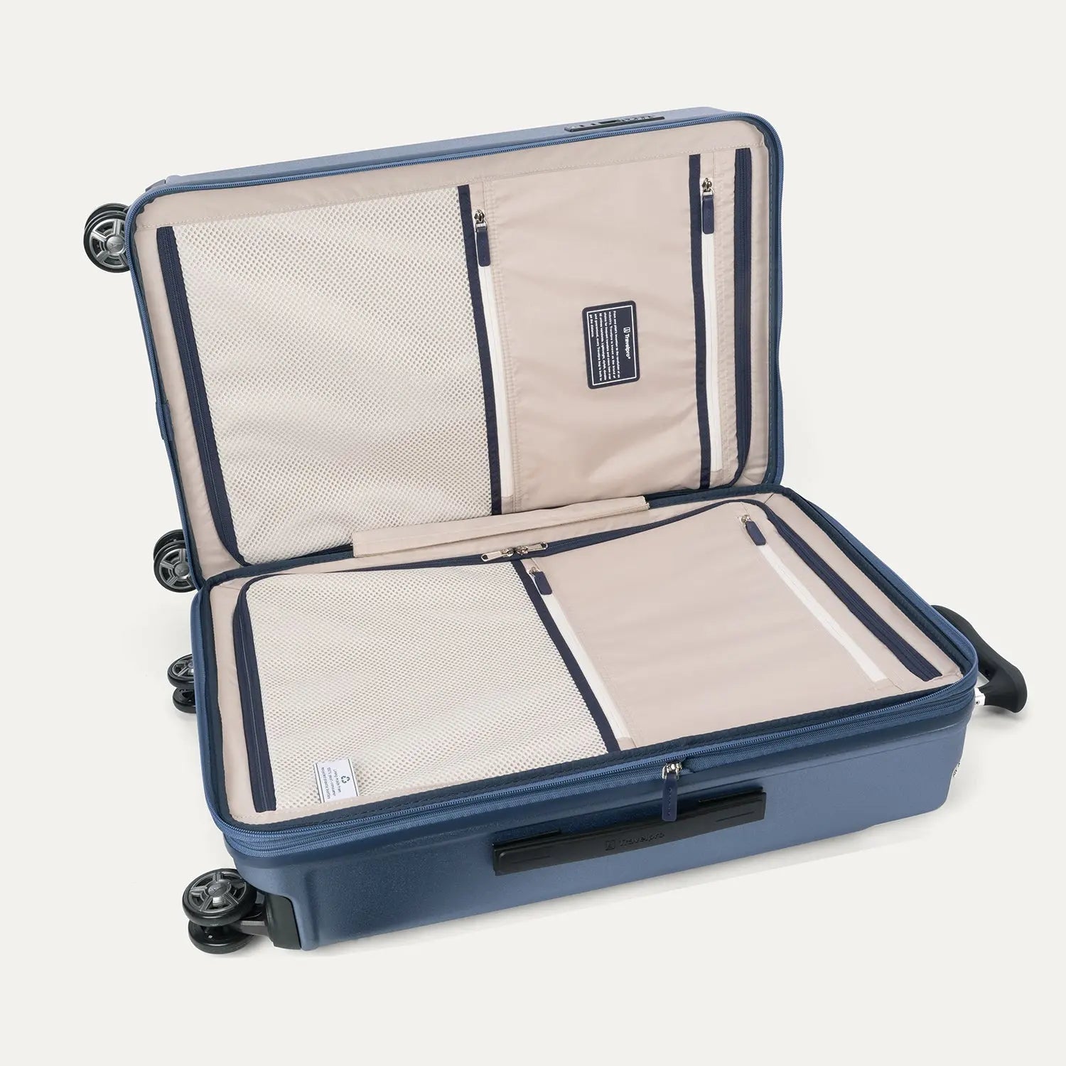 Interior packing view of the Travelpro Platinum Elite Medium Check-In Hardside Spinner in Dark Sky Blue, featuring dual zippered divider panels and the ECOFAB™ lining made from 100% recycled plastic bottles.